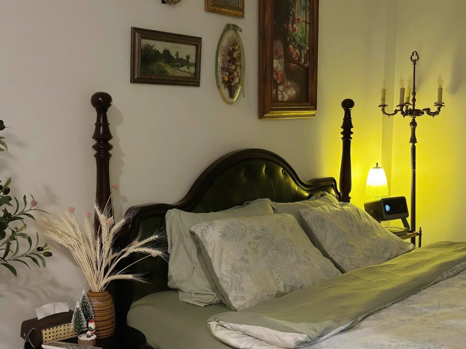 Green leather headboard and framed artwork in the Amalfi room