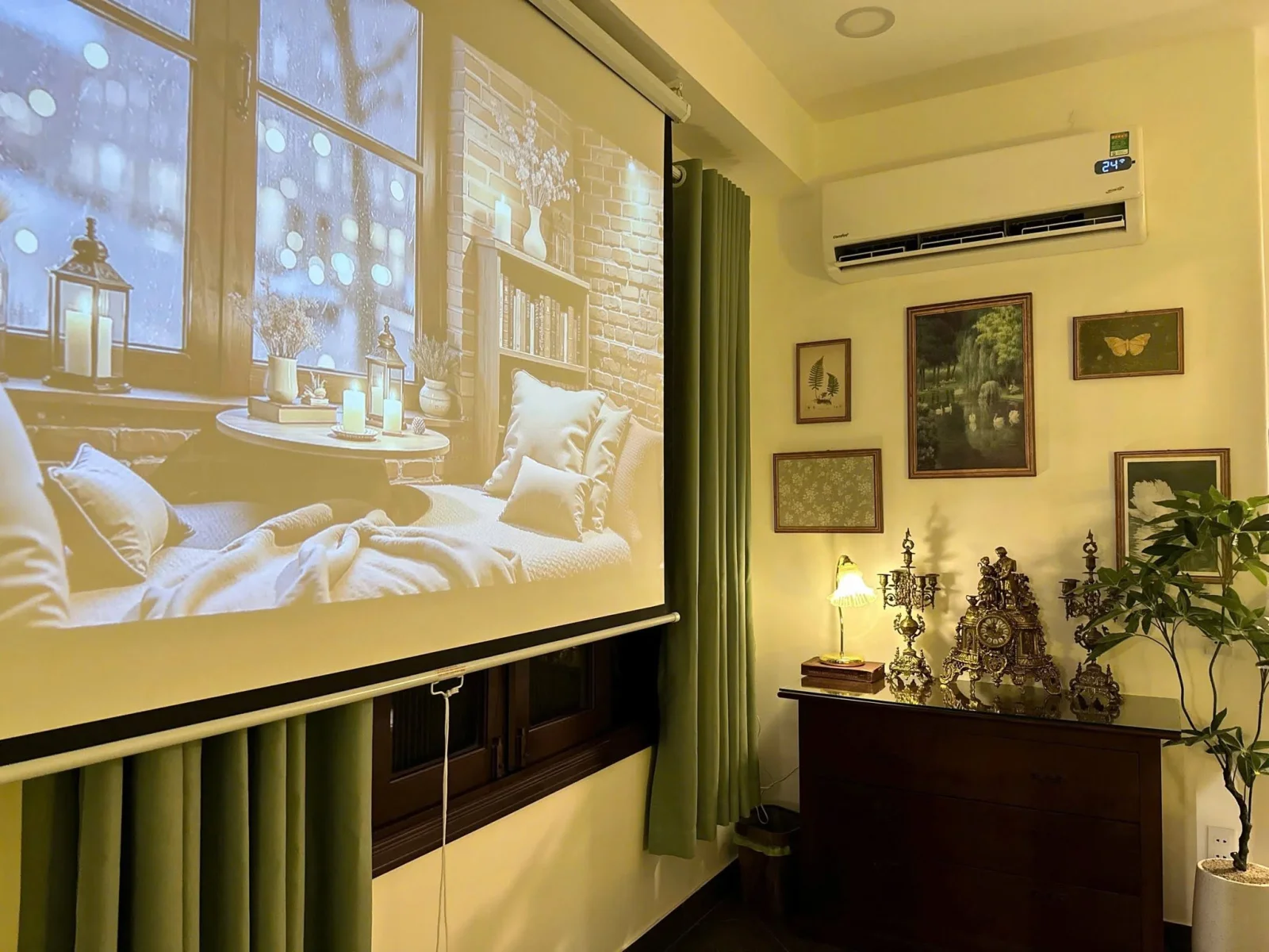 The projector screen in the Amalfi room, with green curtains and a wooden dresser